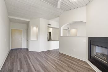 a living room with a fireplace and a wooden floor